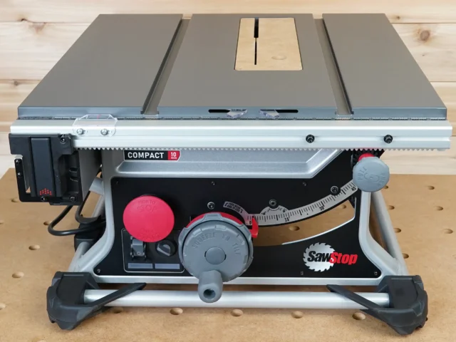 Zero clearance MDF insert installed in SawStop Compact table saw, with light wood insert visible and blade slot centered