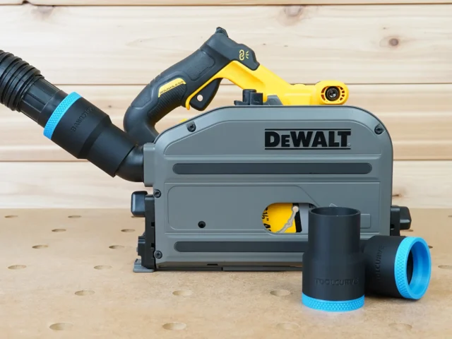 Black 1-7/8 inch hose adapter with blue cuff joining a vacuum hose to a DeWalt track saw, two spares nearby