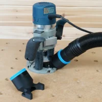 Black 2-1/2 inch hose adapter with blue collar on Bosch 1617 plunge router, second adapter on the bench