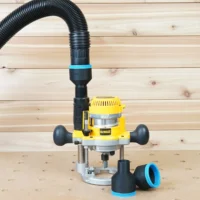 Black 2-1/2 inch hose adapter with blue band joining an extractor hose to a Dewalt plunge router, two spares nearby