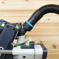 Black hose adapter with blue band joining a 2-1/2 inch ribbed hose to the 27mm dust port on a Festool tool