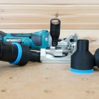 Black and blue ToolCurve 2-1/2 inch hose adapter set shown with dust hose attached beside a Makita plate joiner