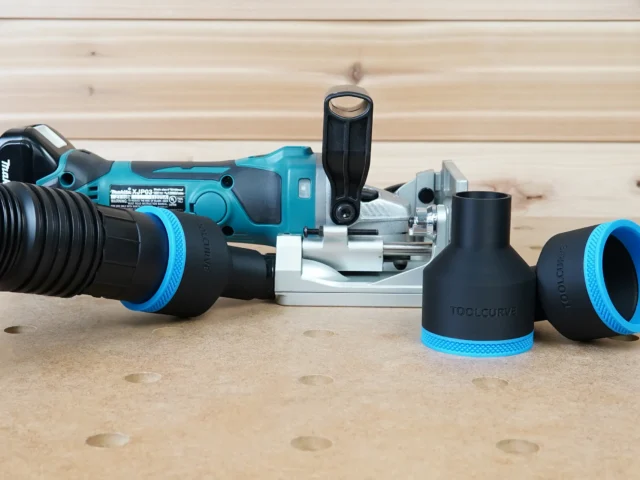 Black and blue ToolCurve 2-1/2 inch hose adapter set shown with dust hose attached beside a Makita plate joiner