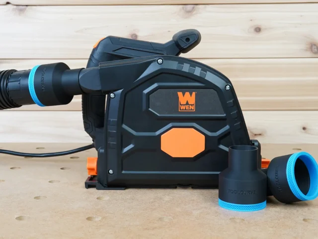Black 2-1/2 inch ToolCurve hose adapter with blue ring joining a vac hose to a Wen track saw dust port, spares beside