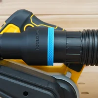 Black ToolCurve 2-1/2 inch hose adapter with blue band installed on a Dewalt 20v belt sander dust port with hose attached
