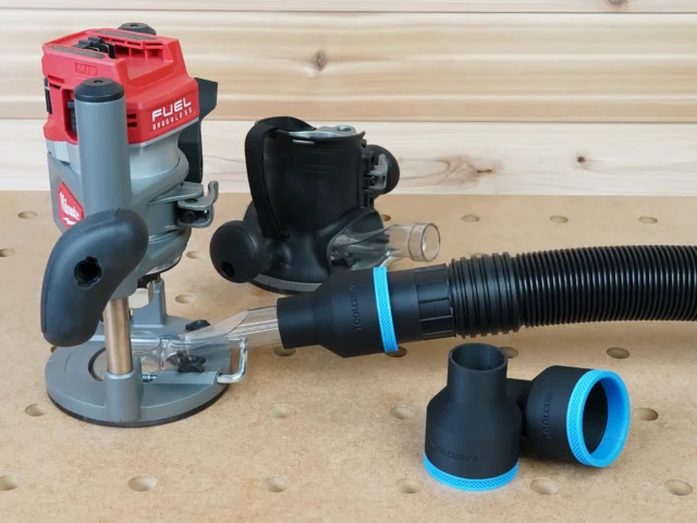 Black 2-1/2 inch hose adapter with blue trim linking a vacuum hose to a Milwaukee M18 router dust port, plus two spare adapters