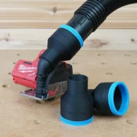 Black 2-1/2 inch hose adapter with blue trim on a Milwaukee 12v cut out tool, two spare adapters beside it