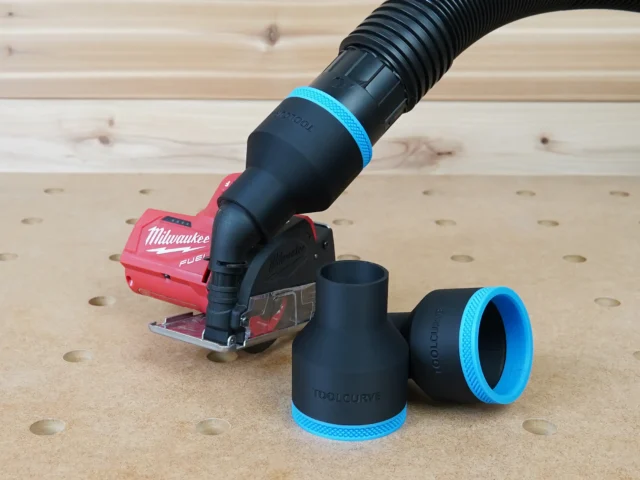 Black 2-1/2 inch hose adapter with blue trim on a Milwaukee 12v cut out tool, two spare adapters beside it