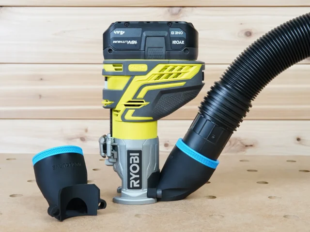 Black 2-1/2 inch hose adapter attached to a Ryobi trim router with vac hose, second adapter beside it