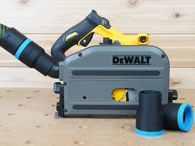 Black 36mm ToolCurve hose adapter with blue cuff joining a hose to a DeWalt track saw, spare adapters beside