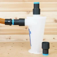 Black 1-1/4" hose adapters with blue bands fitted to an Oneida Dust Deputy cyclone, one linked to an orange hose