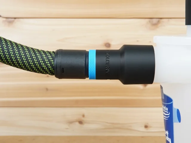 Black hose adapter with blue band attached to braided green and black Festool hose, labeled Oneida