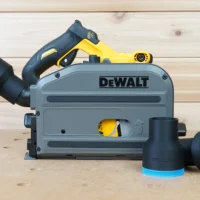 Black ToolCurve 2-1/2 inch hose adapter with blue trim installed on a DeWalt track saw, two spare adapters beside it