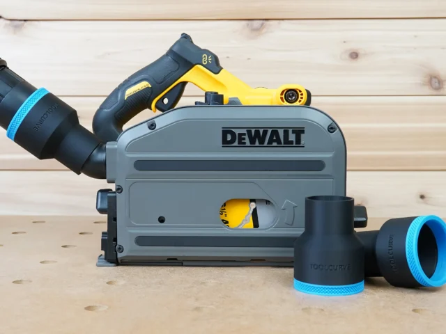Black ToolCurve 2-1/2 inch hose adapter with blue trim installed on a DeWalt track saw, two spare adapters beside it