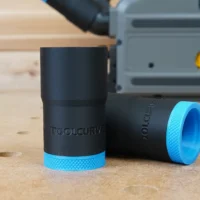 Two black ToolCurve hose adapters with blue textured grip rings, displayed on wood next to a DeWalt track saw