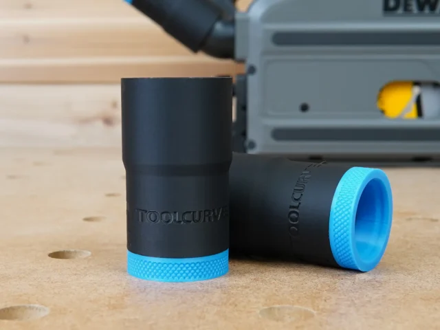 Two black ToolCurve hose adapters with blue textured grip rings, displayed on wood next to a DeWalt track saw