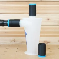 Black 1-7/8 inch ToolCurve hose adapters with blue bands on an Oneida Dust Deputy, spare adapter beside it