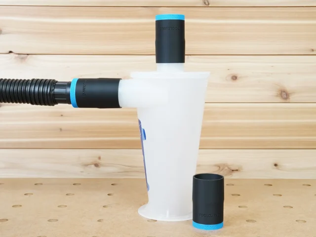 Black 1-7/8 inch ToolCurve hose adapters with blue bands on an Oneida Dust Deputy, spare adapter beside it