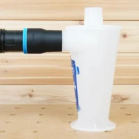 Black ToolCurve 2-1/2 inch hose adapter with blue ring joining a ribbed hose to a white Oneida Dust Deputy inlet