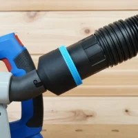 Black 2-1/2 inch hose adapter with blue grip ring joining a ribbed vacuum hose to a blue Kreg track saw dust port