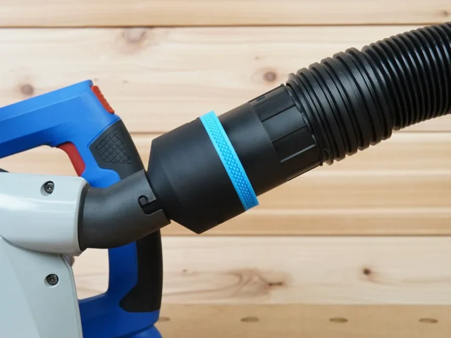 Black 2-1/2 inch hose adapter with blue grip ring joining a ribbed vacuum hose to a blue Kreg track saw dust port