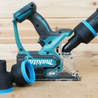 Black 2-1/2 inch hose adapter installed on a Makita XDS01Z cut-out saw with vacuum hose, plus a spare adapter beside it