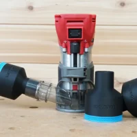 Black 2-1/2 inch ToolCurve hose adapters with blue trim beside a Milwaukee M18 trim router and vacuum hose