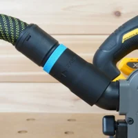 Black hose adapter with blue band attached to Dewalt track saw dust port, connected to green and black braided hose