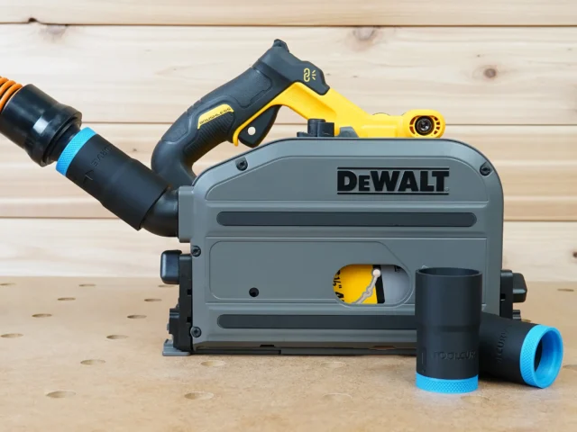 Black 1-1/4" hose adapter with blue collar joining an orange hose to a DeWalt track saw, two spares beside it