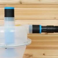 Two black ToolCurve 1-7/8" hose adapters with blue bands on a Cen-Tec Quick-Click separator, one joined to a ribbed hose