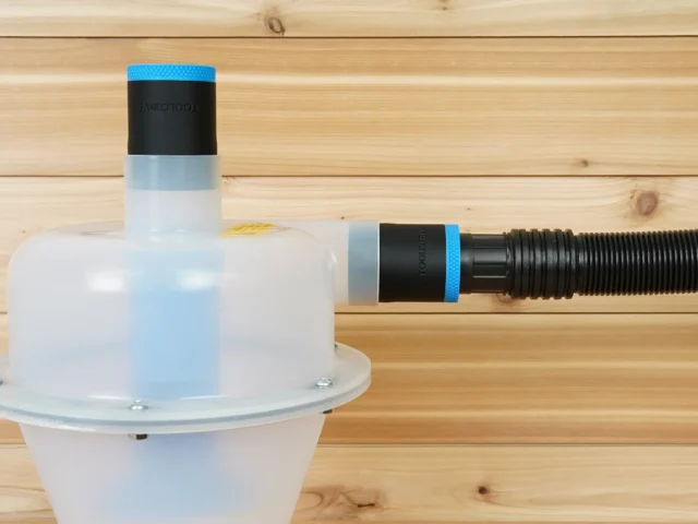 Two black ToolCurve 1-7/8" hose adapters with blue bands on a Cen-Tec Quick-Click separator, one joined to a ribbed hose