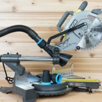 ToolCurve 1-7/8 inch hose adapter with blue trim on a Ryobi 10" sliding miter saw dust port, hose attached