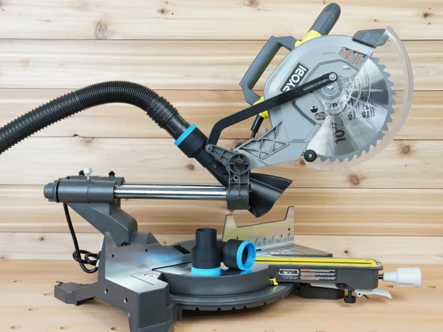 ToolCurve 1-7/8 inch hose adapter with blue trim on a Ryobi 10" sliding miter saw dust port, hose attached