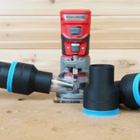Black ToolCurve 2-1/2 inch hose adapter with blue trim connected to a hose beside a red Craftsman 20v router