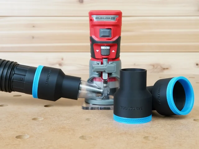 Black ToolCurve 2-1/2 inch hose adapter with blue trim connected to a hose beside a red Craftsman 20v router