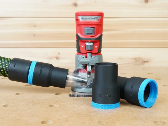 Black 36mm hose adapter with blue collar connecting a vacuum hose to a red Craftsman 20v router, plus a spare adapter