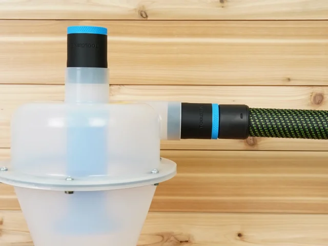 Two black ToolCurve 36mm hose adapters with blue rings on a Cen-Tec separator, one joined to a green hose