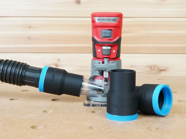 Black 1-7/8 inch hose adapter with blue trim linking a vacuum hose to a red Craftsman 20v router, plus two spare adapters