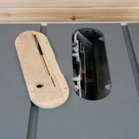 Zero Clearance insert for Milwaukee M18 table saw, made from light MDF with a center slot, shown installed next to the standard black insert