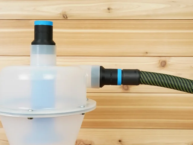 Hose adapter with blue knurled grip and black body connected to a Cen-Tec Quick-Click separator and yellow-green braided hose