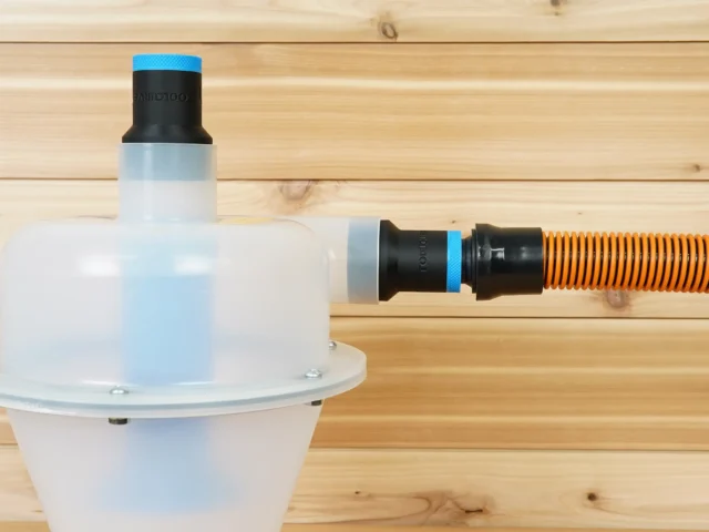Two black ToolCurve 1-1/4 inch hose adapters with blue rings on a Cen-Tec Quick-Click separator, one joined to an orange hose