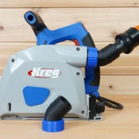No Snag Dust Port attached to a Kreg track saw, with orange hose angled upward and away from the saw body