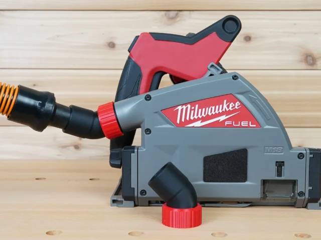 No Snag Dust Port for Milwaukee track saw attached to gray and red Milwaukee FUEL circular saw, showing angled black hose adapter with yellow flex hose connected