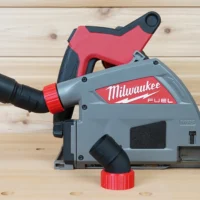 No Snag Dust Port for Milwaukee track saw attached to gray and red Milwaukee FUEL saw, with black hose connected and angled upward