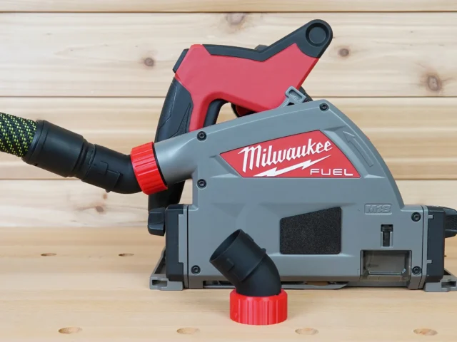 No Snag Dust Port for Milwaukee track saw attached to gray and red Milwaukee FUEL saw, with black hose connected and angled upward