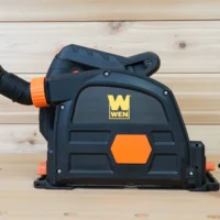 Black and orange no snag dust port attached to a Wen track saw, with removable hose adapters shown separately