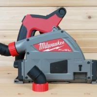 Black no snag dust port with red threaded collar installed upward-angled on a Milwaukee M18 Fuel track saw
