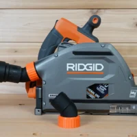 No snag dust port adapter attached to a Ridgid track saw, showing the angled hose connection and quick-change port design
