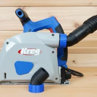 No Snag Dust Port for Kreg track saw mounted on blue Kreg saw, with black hose attached upward and angled away from tool