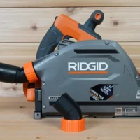 No Snag Dust Port for Ridgid track saw mounted on gray and orange Ridgid track saw, showing angled hose port and quick-change adapter design